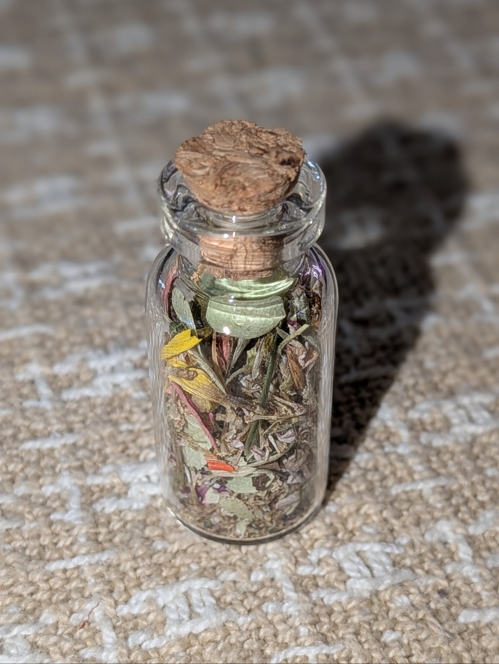 Little Glass Vial Filled with Dried Botanicals
